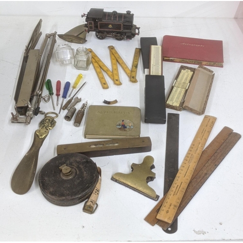 425 - A mixed lot to include a group of vintage tools, a level tube measuring reel, rulers and others toge... 