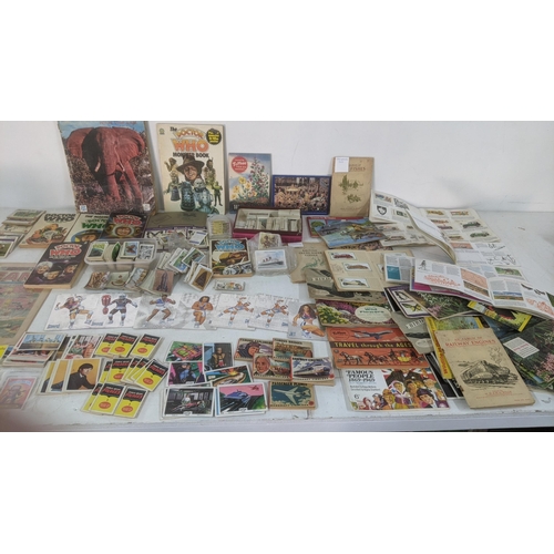 429 - A mixed lot of ephemera to include a collection of mostly filled cigarette card books, with loose ex... 