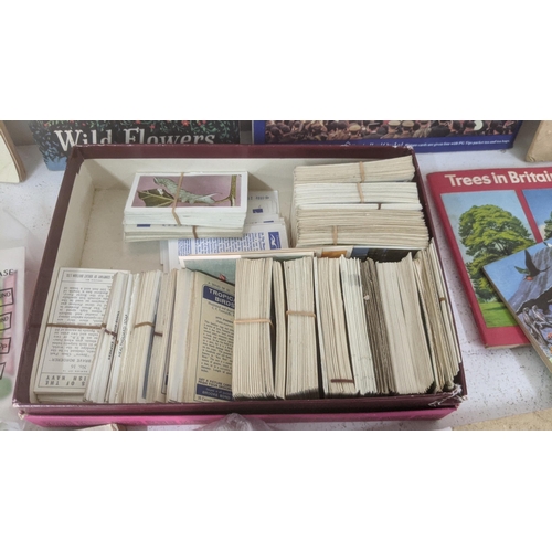 429 - A mixed lot of ephemera to include a collection of mostly filled cigarette card books, with loose ex... 