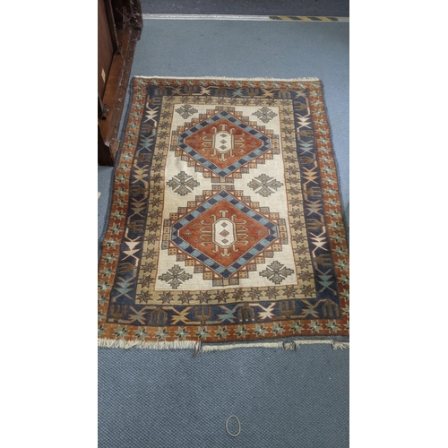 435 - A Turkish hand woven rug having repeating motifs cream ground with multi guard borders and tasselled... 