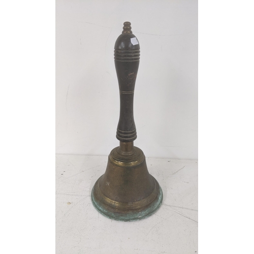 438 - A late 19th/early 20th century brass bell having a treen turned handle, 38cm high
Location: 2-4
If t... 