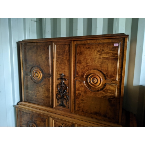 431 - A reproduction Continental cabinet having four cupboard doors with two central scroll carved motifs ... 