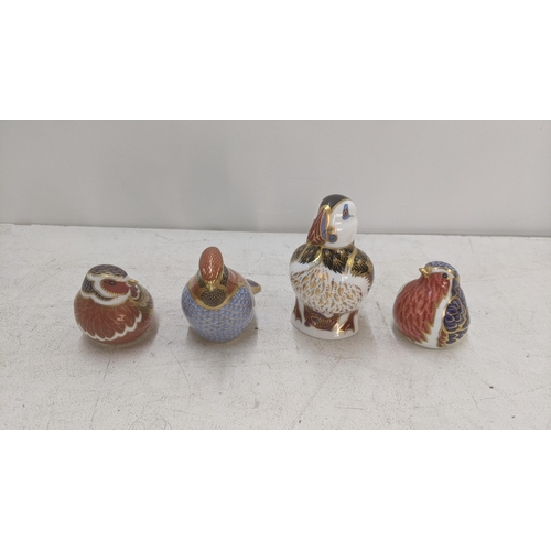 566 - Four Royal Crown Derby paperweights to include 'Robin' with gold stopper, 'Gold Finch Nesting' with ... 