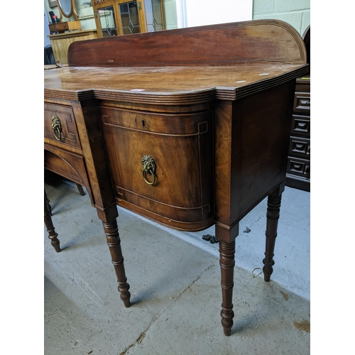 552 - A Georgian mahogany breakfront sideboard with extended back, central drawer flanked by cellarette dr... 