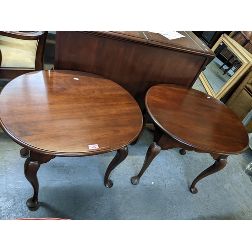 555 - A pair of contemporary mahogany lamp tables, oval tops with moulded edge, single frieze drawer on ca... 