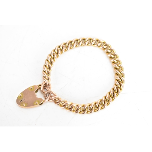 115A - A 9ct gold curb chain link bracelet with a heart shaped padlock clasp, stamped 9ct, 15.1 grams
If th... 