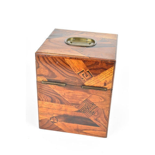 116 - A circa 1900 Japanese parquetry decanter box, decorated with offset panels of specimen woods, the in... 