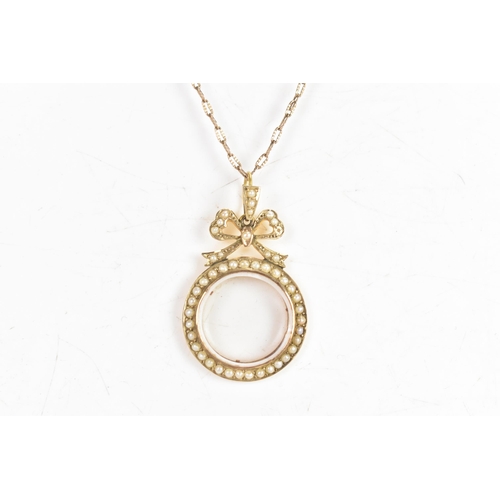 120A - An Edwardian seed pearl 9ct gold double sided locket pendant and yellow metal chain, the pendant hav... 