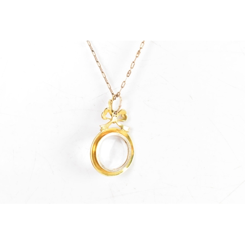 120A - An Edwardian seed pearl 9ct gold double sided locket pendant and yellow metal chain, the pendant hav... 