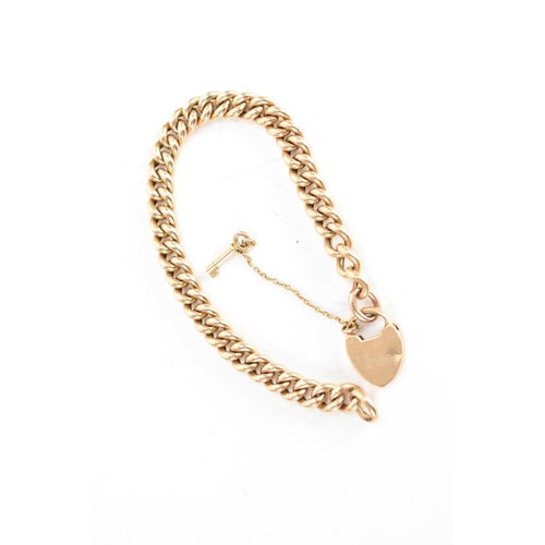 125A - A 15ct gold curb chain link bracelet with a heart shaped padlock clasp, together with safety chain a... 