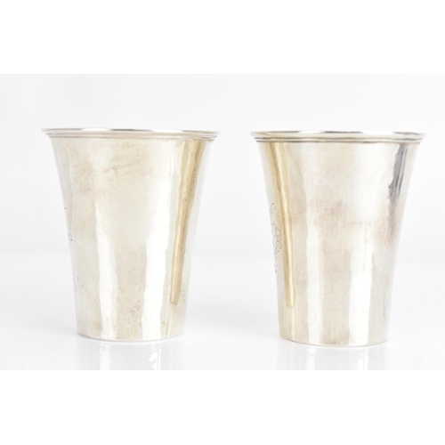 31 - Two 1920s Georg Jensen Danish silver cups, each of tapering form, one engraved with flowers and the ... 