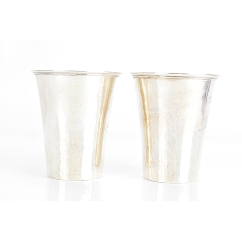 31 - Two 1920s Georg Jensen Danish silver cups, each of tapering form, one engraved with flowers and the ... 