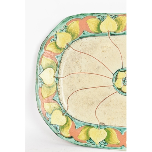34 - A circa 1900 Della Robbia pottery meat plate, having a central flower head motif with branches termi... 