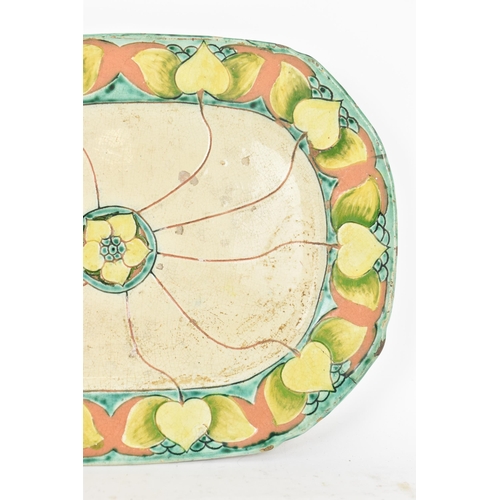 34 - A circa 1900 Della Robbia pottery meat plate, having a central flower head motif with branches termi... 