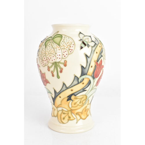 4 - A Moorcroft vase, in the 'Golden Lily' pattern, tube lined on an ivory ground and of baluster form, ... 