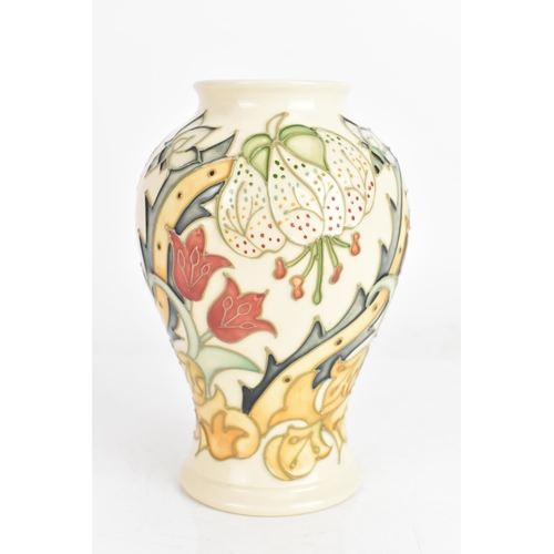 4 - A Moorcroft vase, in the 'Golden Lily' pattern, tube lined on an ivory ground and of baluster form, ... 