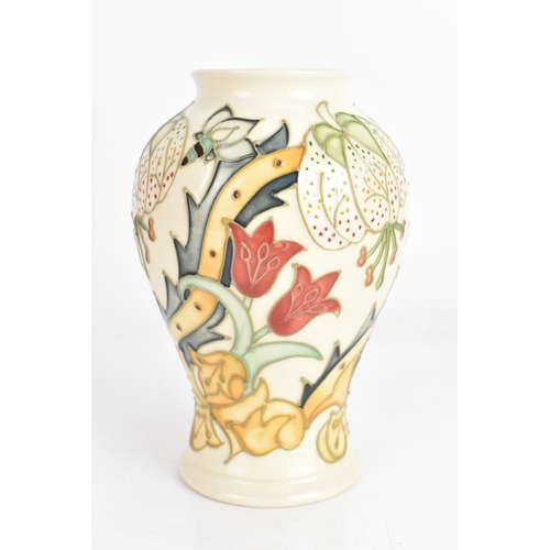 4 - A Moorcroft vase, in the 'Golden Lily' pattern, tube lined on an ivory ground and of baluster form, ... 