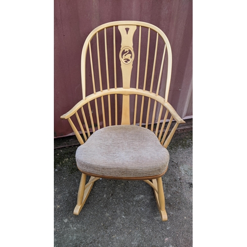 40A - A vintage Ercol light elm and beech 'Swan Back' rocking chair on sleigh rockers, turned legs united ... 