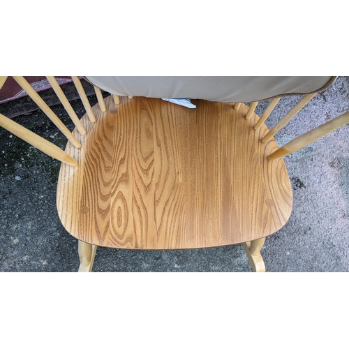 40A - A vintage Ercol light elm and beech 'Swan Back' rocking chair on sleigh rockers, turned legs united ... 