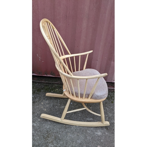 40A - A vintage Ercol light elm and beech 'Swan Back' rocking chair on sleigh rockers, turned legs united ... 