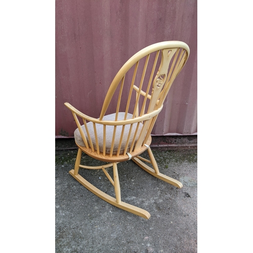 40A - A vintage Ercol light elm and beech 'Swan Back' rocking chair on sleigh rockers, turned legs united ... 