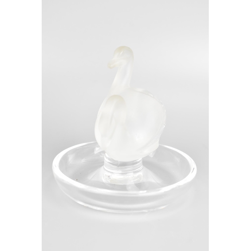 43 - A Lalique glass ring dish, the centre moulded as two frosted swans, the base etched 'Lalique France'... 