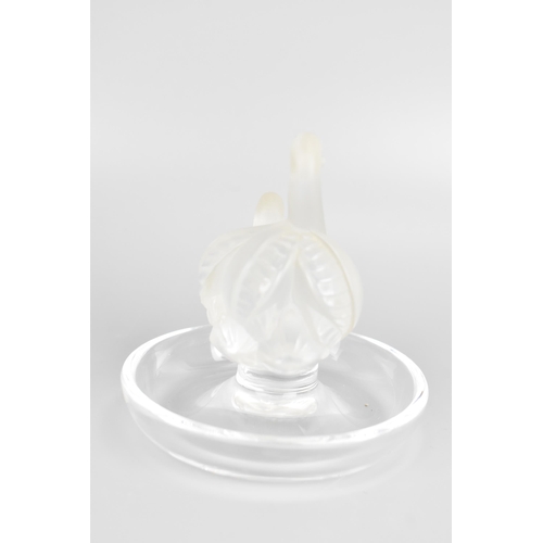 43 - A Lalique glass ring dish, the centre moulded as two frosted swans, the base etched 'Lalique France'... 