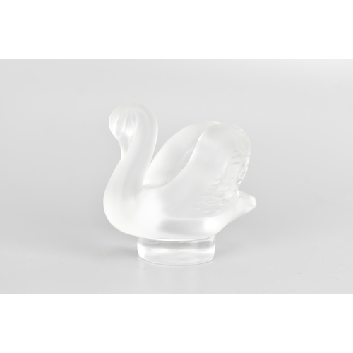 44 - A Lalique glass paperweight, fashioned as a frosted swan, the rim etched 'Lalique France', 5cm high ... 