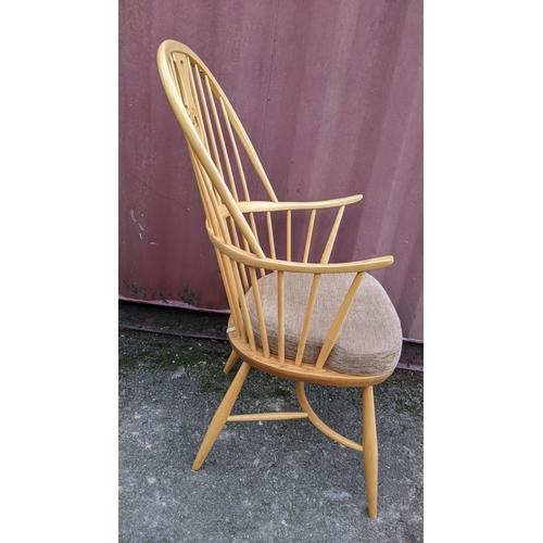 50A - A vintage Ercol light elm and beech 'Swan Back' armchair, with turned legs united by a crinoline str... 