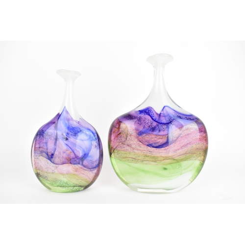 59 - Two Thomas Petit studio glass 'Moors' flattened bottle vases, each in shades of purple, pink and gre... 