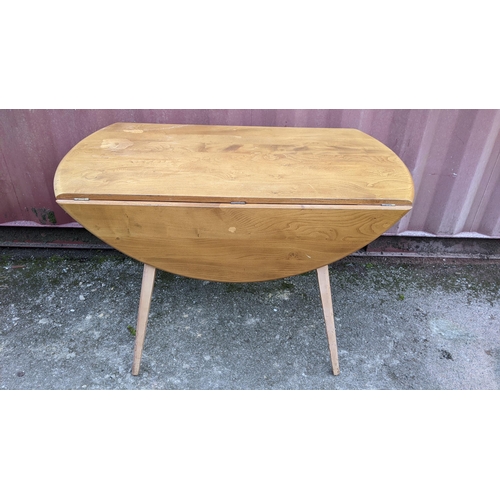 60A - A 1960s Ercol blond elm 'Windsor' model 384 fall flap kitchen table and four model 376 beech and elm... 