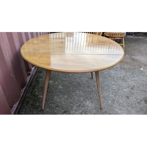 60A - A 1960s Ercol blond elm 'Windsor' model 384 fall flap kitchen table and four model 376 beech and elm... 