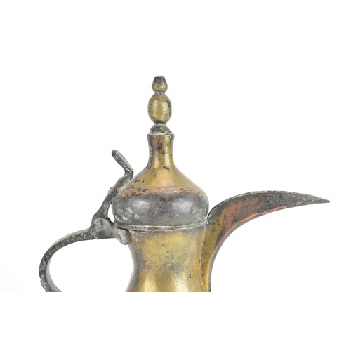 118 - A 19th century Dallah brass coffee pot, of hourglass form with an oversized spout, finial top with a... 