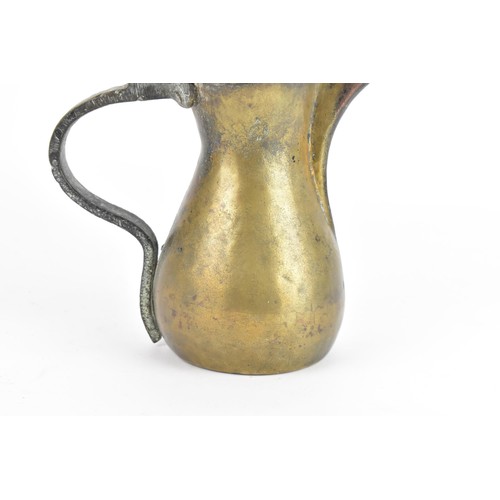 118 - A 19th century Dallah brass coffee pot, of hourglass form with an oversized spout, finial top with a... 