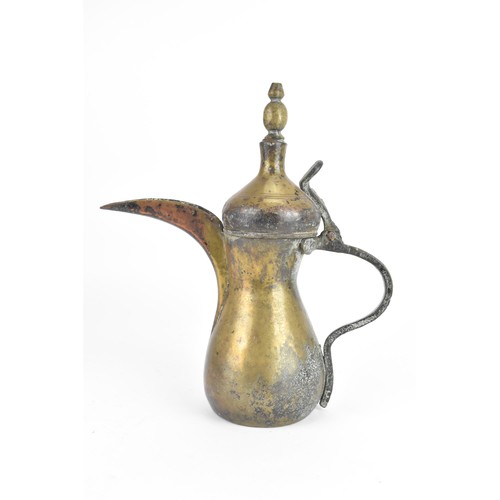 118 - A 19th century Dallah brass coffee pot, of hourglass form with an oversized spout, finial top with a... 