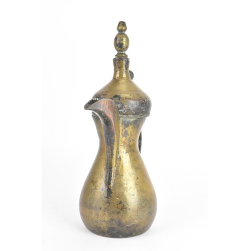 118 - A 19th century Dallah brass coffee pot, of hourglass form with an oversized spout, finial top with a... 