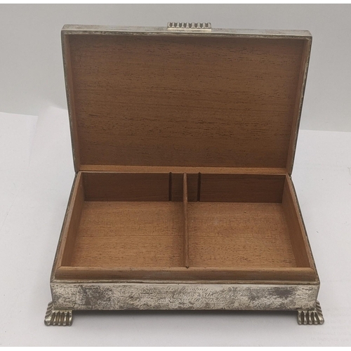 1 - A silver cigarette box having and engine turned lid on four feet with engraved inscription to the fr... 