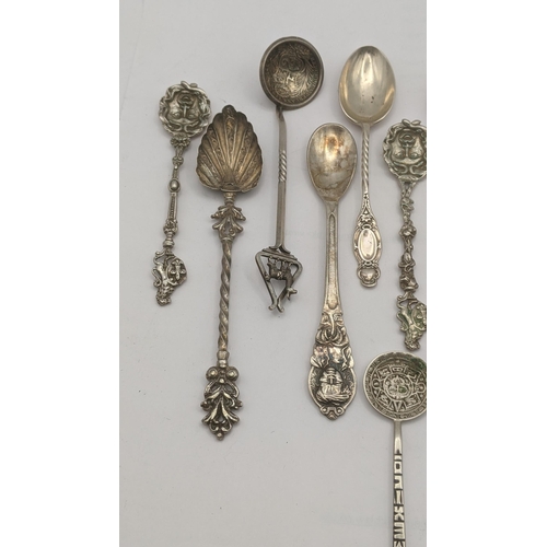 10 - A group of silver; 900 grade silver and 800 grade silver and white metal collector tea spoons to inc... 