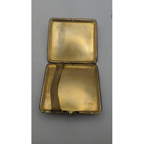 28 - A silver Cohen and Charles engine turned cigarette case having gilt interior, hallmarked Chester 192... 