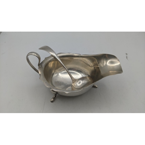 50 - A viner silver sauce boat on three feet and small sauce ladle, both hallmarked Sheffield 1932, total... 