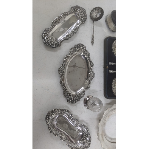 51 - A mixed silver and silver topped crystal cut glass items to include embossed pin dishes, a two-piece... 