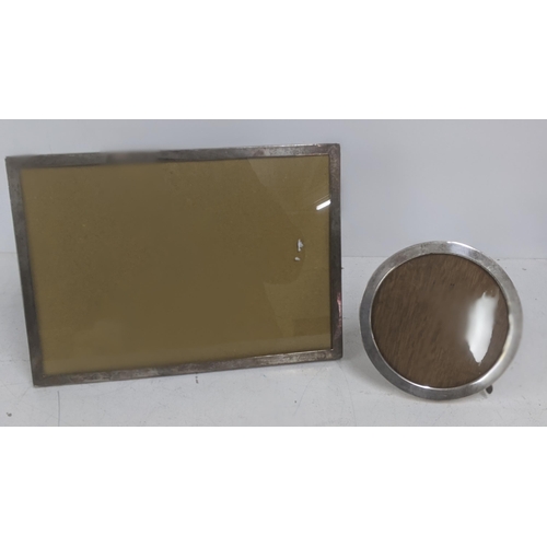 62 - Two silver photograph frames to include a rectangular example 24cm x 33.5cm along with another examp... 