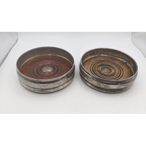 64 - A pair of silver wine coasters, makers Marks W.E.V. one example hallmarked London 1996 and the other... 