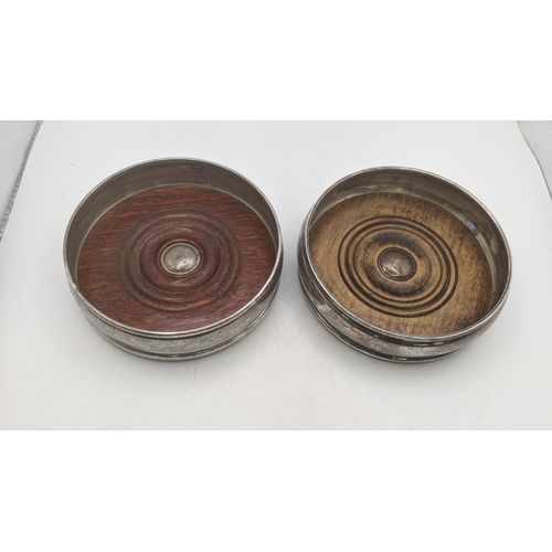 64 - A pair of silver wine coasters, makers Marks W.E.V. one example hallmarked London 1996 and the other... 