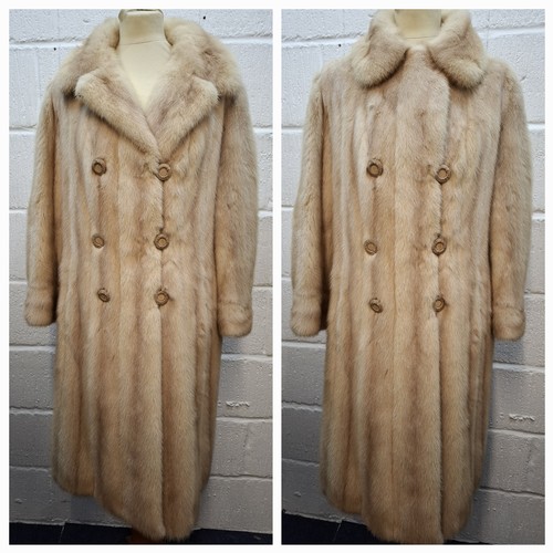 A vintage blonde mink calf length coat having 6 fabric covered buttons, 2 side pockets and deep cuffs with embroidered initials to lining, approx 40" chest x 40" long. Location:Rail
Condition: No belt, no loss of fur, stiffening or strong smells, various stains to areas of the brown satin lining-see additional photos