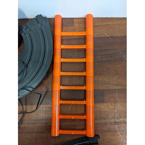 21 - An Aurora World Championship Motor Racing set with two remote controllers, four cars, track, and pla... 