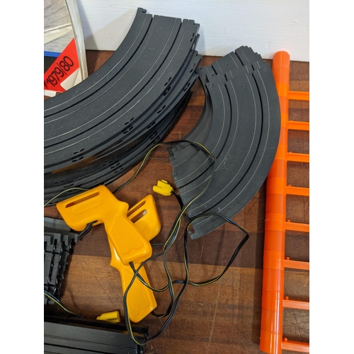 21 - An Aurora World Championship Motor Racing set with two remote controllers, four cars, track, and pla... 