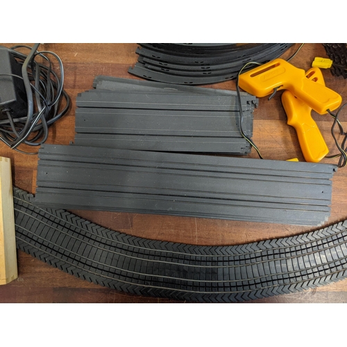 21 - An Aurora World Championship Motor Racing set with two remote controllers, four cars, track, and pla... 