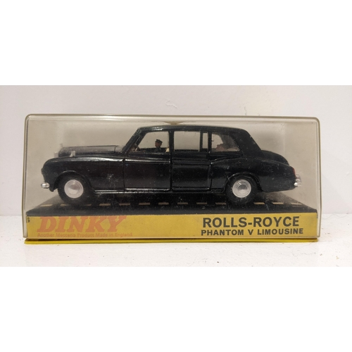 57 - Dinky Toys 152 Rolls Royce Phantom V Limousine, in navy blue with a cream interior with a driver and... 