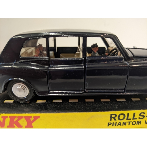 57 - Dinky Toys 152 Rolls Royce Phantom V Limousine, in navy blue with a cream interior with a driver and... 